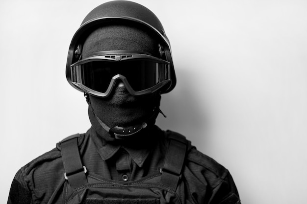 SWAT in black uniform face mask and bulletproof vest Black and white photo