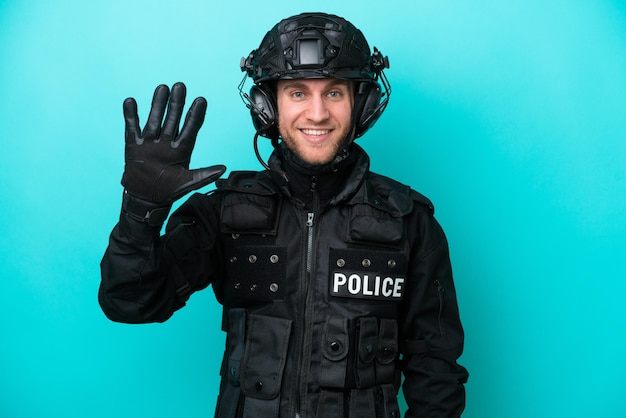 SWAT caucasian man isolated on blue background counting five with fingers