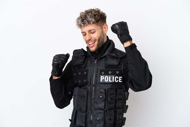 SWAT caucasian man isolated on white background celebrating a victory