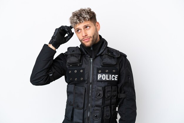 SWAT caucasian man isolated on white background having doubts and with confuse face expression