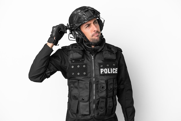 SWAT caucasian man isolated on white background having doubts and with confuse face expression