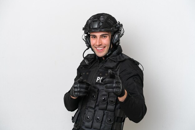 SWAT caucasian man isolated on white background pointing to the front and smiling