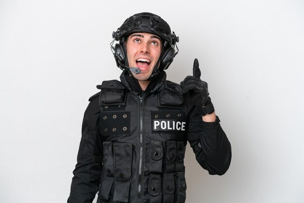 SWAT caucasian man isolated on white background pointing up and surprised