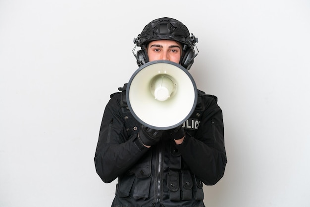 SWAT caucasian man isolated on white background shouting through a megaphone