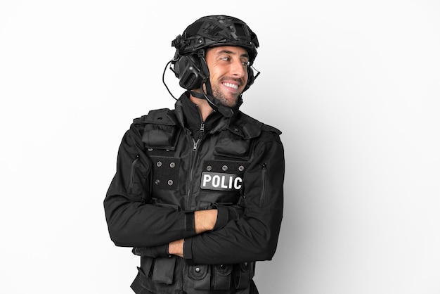 SWAT caucasian man isolated on white background with arms crossed and happy