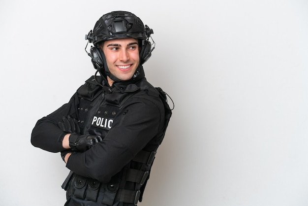 Swat caucasian man isolated on white background with arms\
crossed and happy