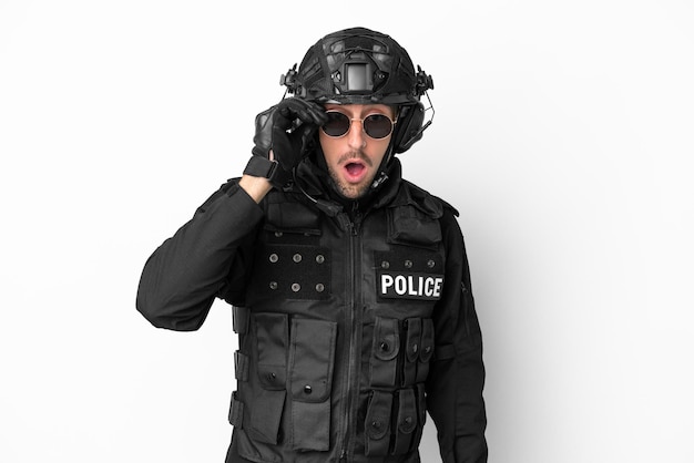 SWAT caucasian man isolated on white background with glasses and surprised