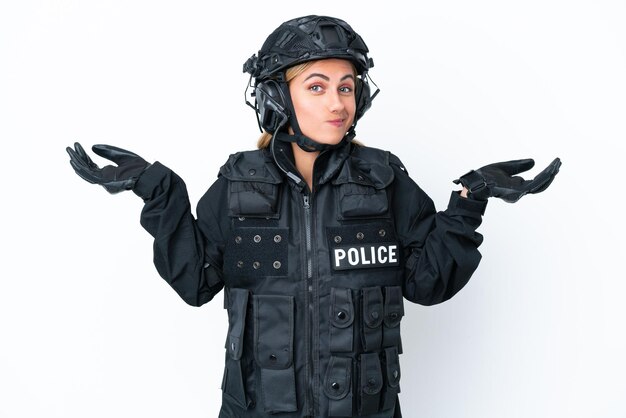 SWAT caucasian woman isolated on white background having doubts while raising hands