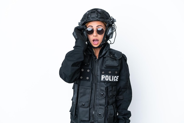 SWAT caucasian woman isolated on white background with glasses and surprised