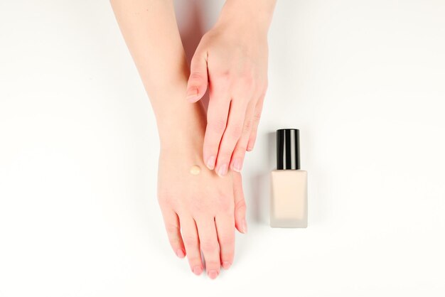 Swatch of foundation on the hand isolated on white