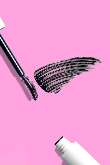 swatch mascara brushstroke smear mascara brush composition cosmetic on pink background flat lay vertical