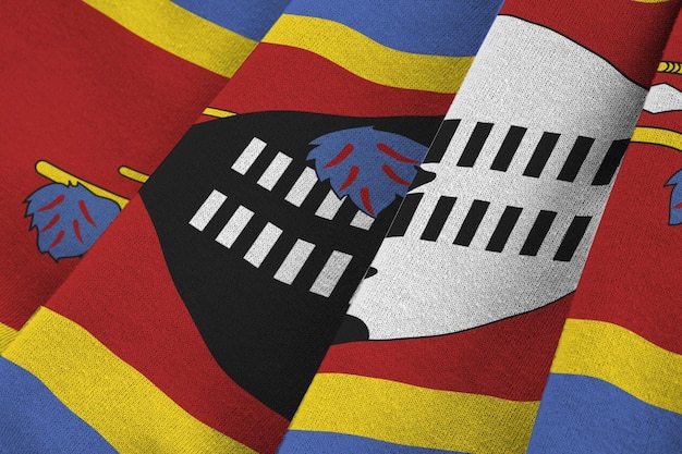 Swaziland flag with big folds waving close up under the studio light indoors the official symbols an