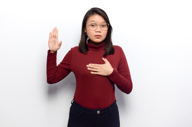 Swearing gesture of Young beautiful asian women dress red shirt isolated on white background