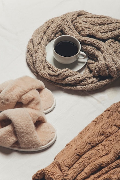 a sweater coffee and a candle on a white background  winter cozy image