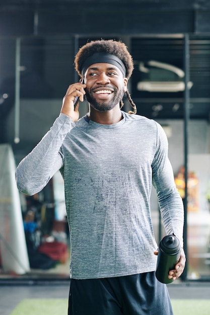 Sweaty sportsman talking on phone