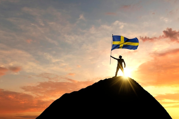 Sweden flag being waved at the top of a mountain summit d rendering