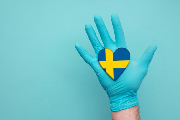 Sweden medical health heart nurse hand holding country heart flag