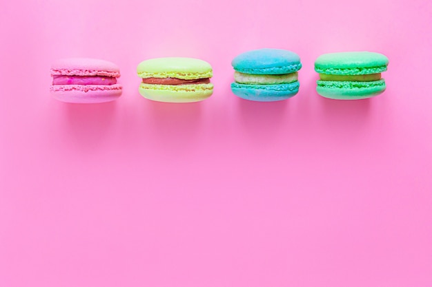 Sweet almond colorful macaron dessert cake isolated on pink pastel background