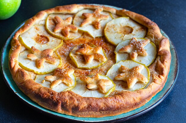 Sweet apple pie with biscuits on the table