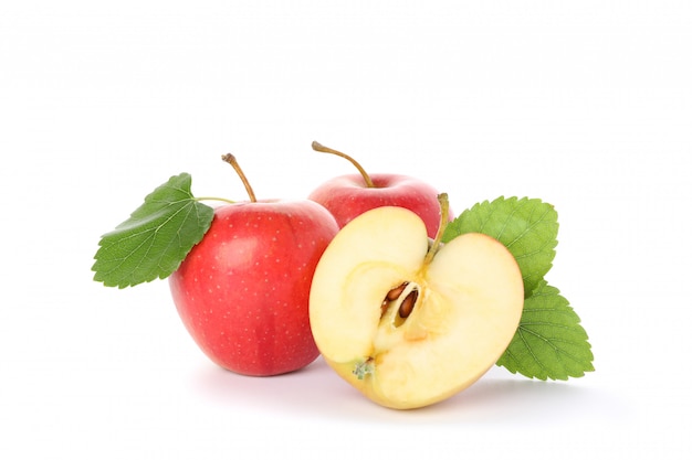 Sweet apples with leaves on white table