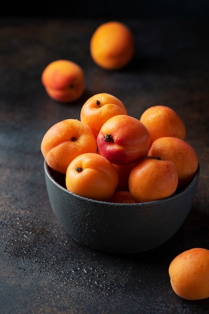 Sweet apricots in a dark table