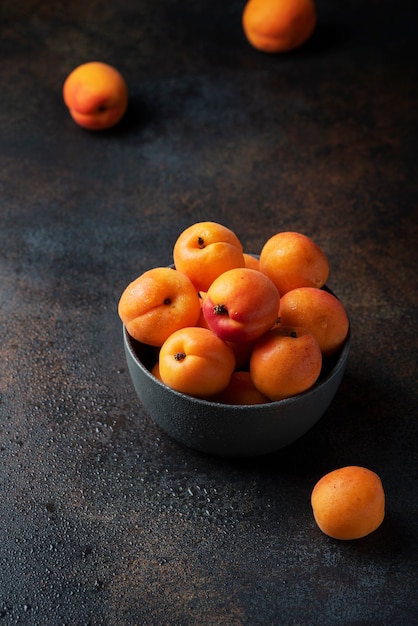 Sweet apricots in a dark table