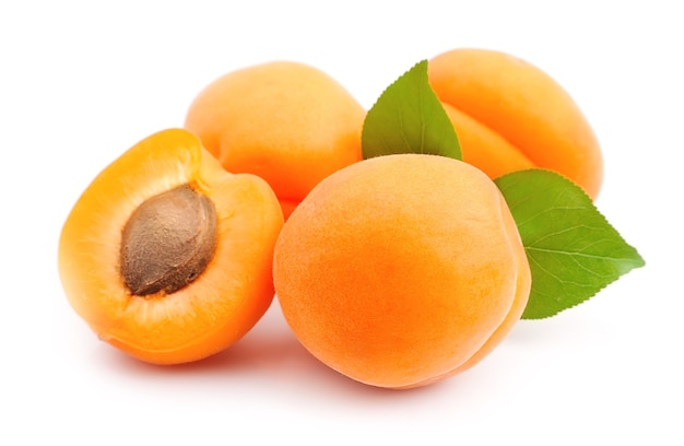 Sweet apricots fruits with leafs on white