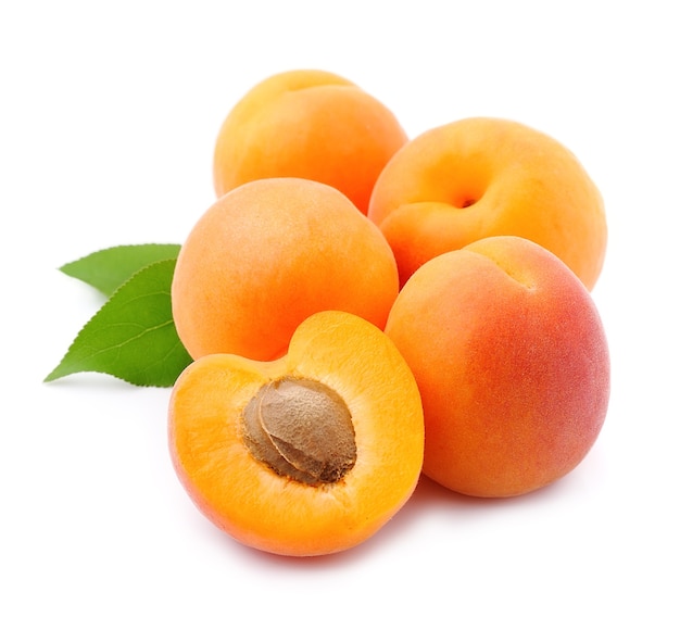 Sweet apricots with leaves isolated on white