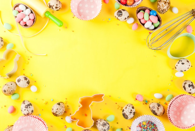Sweet baking concept for Easter cooking background with baking - with a rolling pin whisk for whipping cookie cutters quail eggs sugar sprinkling 