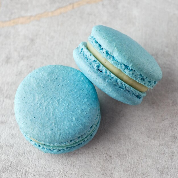 Sweet banana macarons on a stone background Traditional French dessert