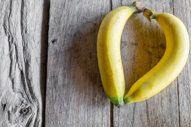 Sweet bananas on old wooden table