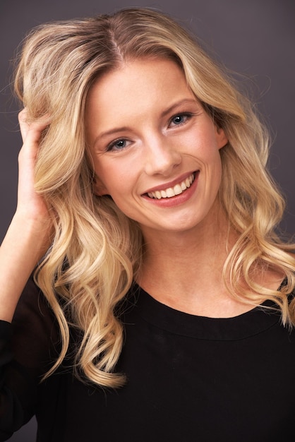 Sweet and beautiful Portrait of a beautiful young blonde woman smiling sweetly in studio