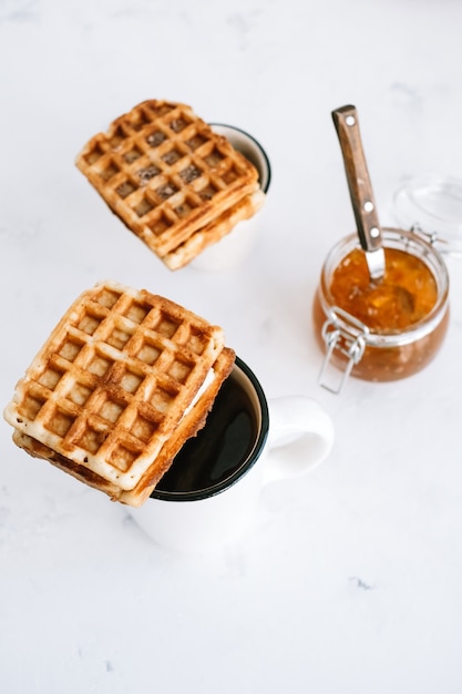 Sweet Belgian waffles on a cup of tea.