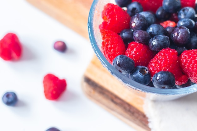 Sweet berries of raspberry and blueberry close up on white background