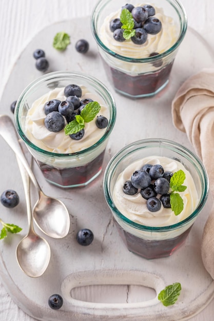 Sweet blue jelly served in glass with blueberries