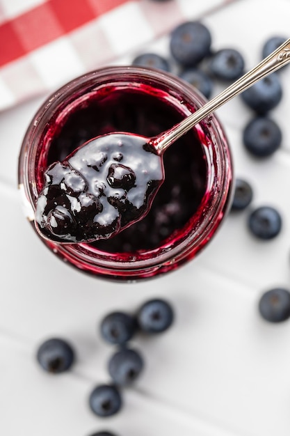 Sweet blueberry jam in spoon top view