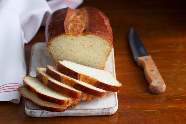 Sweet bread and slices of bread on a wooden table. Selective focus.