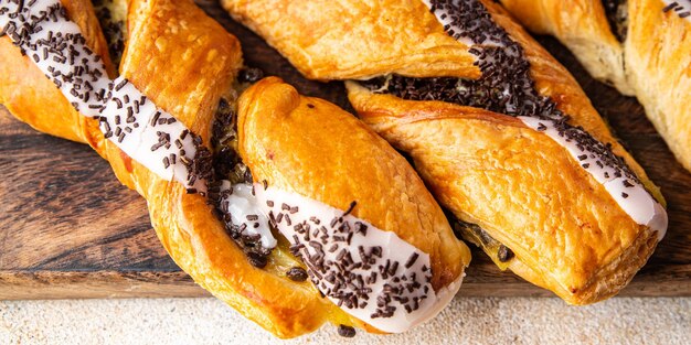 Sweet bun puff pastry cream filling, chocolate drops healthy meal food snack on the table