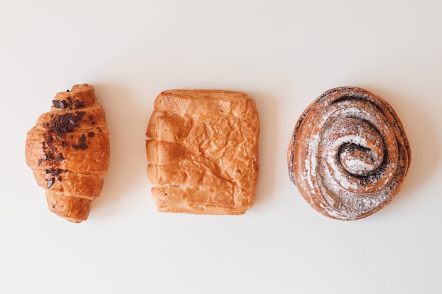 Sweet bun roll swirl, croissant and puff isolated over white background