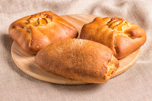 Sweet buns on a wooden board 