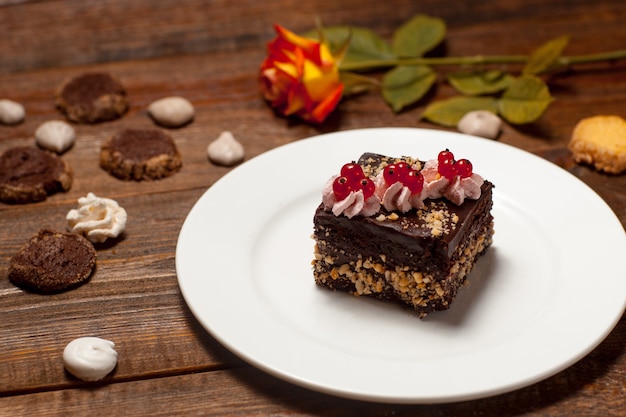 Sweet cake on plate wooden table