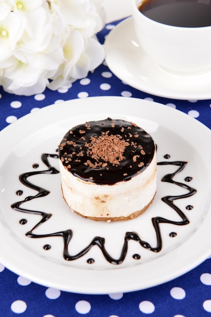 Sweet cake with chocolate on plate on table close-up