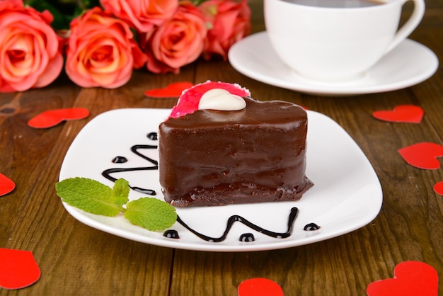 Sweet cake with chocolate on plate on table close-up