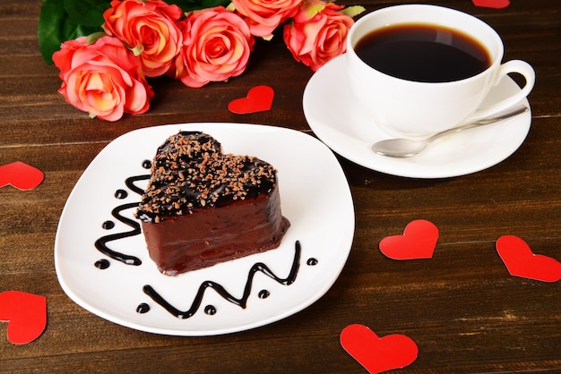 Sweet cake with chocolate on plate on table close-up