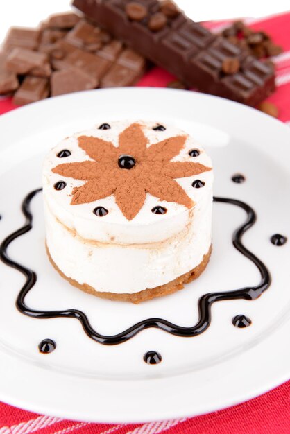 Sweet cake with chocolate on plate on table close-up