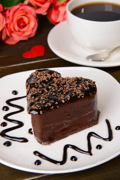 Sweet cake with chocolate on plate on table close-up