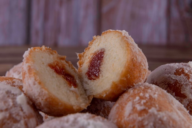 Sweet cake with guava filling cut in half showing the filling known locally Brazil as Sonho in Portuguese dream in English covered with refined sugar Selective focus