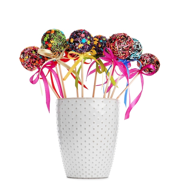 Sweet cakepops in glass on white background