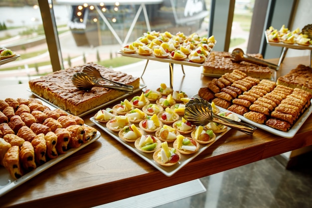 Sweet cakes on event catering. Fruit baskets