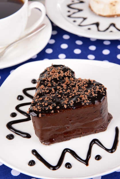 Sweet cakes with chocolate on plate on table close-up